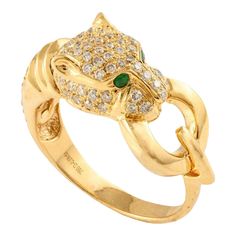 Diamond Studded Panther Head Ring Crafted in 18K Gold featuring natural emerald of 0.03 carats and diamonds of 0.5 carats. The gorgeous handcrafted ring goes with every style. Emerald enhances intellectual capacity of the person. Designed with a panther head studded with diamonds and emerald studded in the eye holding a gold ring from its mouth making a cocktail ring that makes it a perfect fit to wear it on your occasion or style it with any of your basic outfit to give it a glam. This is a per Luxury Yellow Gold Emerald Ring With Diamond, Gold Emerald Ring With Pave Setting, Gold Emerald Ring With Pavé Setting, Gold Emerald Diamond Ring With Accents, Luxury Gold Emerald Ring With Pave Setting, Formal Yellow Gold Emerald Ring With Pave Setting, Gold Emerald Ring With Diamond And Hallmarked, Gold Emerald Rings With Pave Setting, Fine Jewelry Emerald Ring In Yellow Gold With Diamond