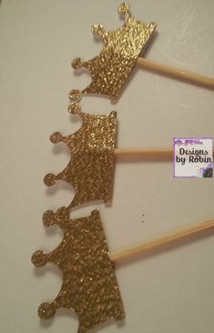 gold glitter cake toppers with crowns on them