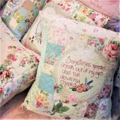 three pillows that have been made with different patterns and colors, one has a quote on it