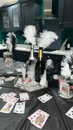 the table is set up with cards and wine bottles for playing card games on it