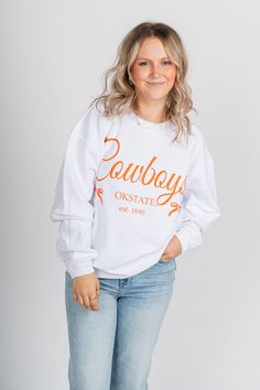 OSU Cowboys bows corded sweatshirt from Lush Fashion Lounge women's boutique in Oklahoma City. Lush boutique in Oklahoma is known for a large selection of Okie apparel, Oklahoma t-shirts and OSU Cowboys gameday apparel. Officially licensed by Oklahoma State University. 100% cotton Model is 5'2 size 25 wearing small. White Sweatshirt For College In Spring, White Spring College Sweatshirt, White Spring Sweatshirt For College, Osu Cowboys, Oklahoma State University, Sweatshirt White, Oklahoma State, Women's Boutique, Oklahoma City