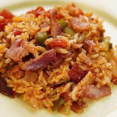 a white plate topped with rice and bacon