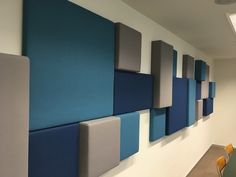 an office with blue and grey panels on the wall