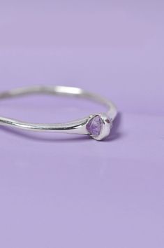 Introducing the Capsule Purple Sapphire Ring in Sterling Silver – a harmonious blend of refined luxury and minimalist jewelery. The hand-set gemstone's inherent beauty elevates the Capsule ring, offering an bespoke touch to your collection. Timelessness meets sophistication in this niche jewellery piece that effortlessly complements your style.Use the drop down menu to select your ring size and have it custom-made just for you. Details925 Sterling Silver jeweleryCustom jewellery handcrafted in o Minimalist Amethyst Birthstone Ring For Anniversary, Minimalist Amethyst Promise Ring, Minimalist Amethyst Birthstone Promise Ring, Minimalist Jewelry With Bezel Setting For Promise, Minimalist Amethyst Jewelry For Promise Ring, Minimalist Amethyst Ring For Anniversary, Minimalist Promise Jewelry With Bezel Setting, Minimalist Amethyst Gemstone Ring, Jewelry With Bezel Setting And Round Stone For Promise