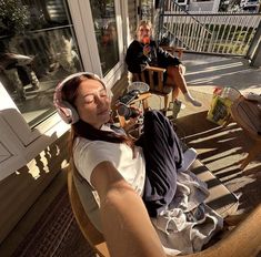 a woman sitting in a chair with headphones on