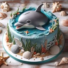 a dolphin cake is decorated with seashells and starfish