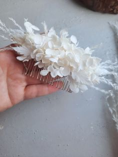 This elegant white hair comb is adorned with delicate hydrangea and fern accents, creating a stunning hair accessory. Perfect for your boho wedding, proms, or any special occasion.
Floral bridal hair comb made made from white preserved hydrangea, miscanthus, phalaris, white fern leaves, small helechrysium flowers.
The perfect wedding accessory for bridesmaids. Bridesmaids hair comb
Available in two sizes.

Hair comb size S :
Height 9 cm| 3.5 inches
Width 6 cm| 2.36 inches

Hair comb size M:
Height 12 cm| 4.7 inches
Width 6 cm| 2.36 inches

Handcrafted with attention to detail, this stunning hair accessory is versatile. The combination of the soft white blooms and lush of the ferns makes this hair comb a timeless and versatile accessory that will complement any outfit. Boho Wedding Hair Accessories, Floral Bridal Hair, Bridesmaid Hair Comb, Preserved Hydrangea, Dried Flowers Wedding, Bridesmaids Hair, Boho Wedding Hair, Fern Leaves, Flower Comb