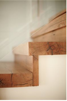 close up view of wooden stairs with white walls