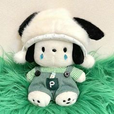 a stuffed animal with a hat on top of it's head and green fur