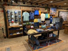 the inside of a clothing store with many items on display