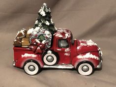 a red truck with a christmas tree in the back