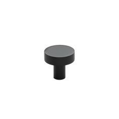 a black round knob on a white background