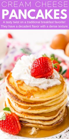 a stack of pancakes with whipped cream and strawberries on top, sitting on a plate