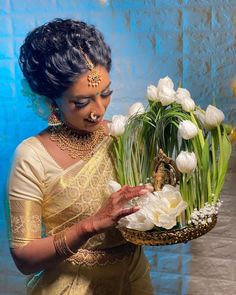 a woman holding a basket filled with white flowers