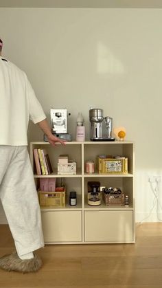 a man standing in front of a book shelf