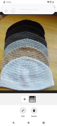 a group of knitted hats sitting on top of a wooden table