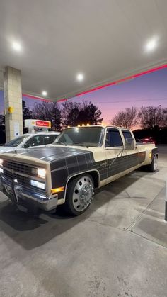 a truck is parked in front of a gas station