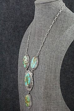 This natural stone Sonoran Mountain turquoise and sterling silver pendant and necklace was expertly crafted by Navajo silversmith Anthony Brown. The back is signed and stamped sterling.Necklace: 17"Lariat Length: 3 1/2"Lariat Width: 1 3/8"Station Length: 1 5/8"Station Width: 1"Free shipping on all orders! We ship with USPS and always include tracking. All orders ship within a day of payment.Returns are accepted up to 30 days after you receive your order. Just send us a message. Our shop offers c Western Style Sterling Silver Necklace With Large Pendant, Western Style Necklace With Large Sterling Silver Pendant, Southwestern Silver Lariat Necklace, Untreated Oval Turquoise Necklace In Bohemian Style, Bohemian Untreated Oval Turquoise Necklace, Vintage Turquoise Lariat Necklace, Vintage Silver Turquoise Necklace With Natural Stones, Bohemian Oval Collectible Necklaces, Bohemian Untreated Silver Turquoise Necklace