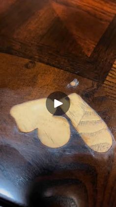 a close up of a piece of wood on top of a wooden table with an object in the middle