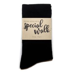 a pair of black socks with the words special walk on it and a tag that says love