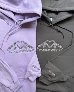 two different colored hoodies with the same logo on them, one in grey and one in purple