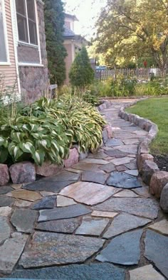 a stone path in front of a house