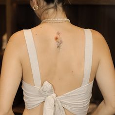 a woman with a flower tattoo on her back