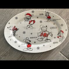 a mickey mouse plate with christmas designs on it