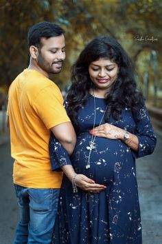 a pregnant couple standing next to each other