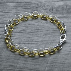 A layered mixed metal dual chain version of our classic sterling silver rolo link charm bracelet! One chain is yellow gold vermeil, and the other is sterling silver. The chains and closure are made in Italy, for an absolutely stunning piece. So shiny and classy! The double strand chain look amazing together and make a nice a statement. Finish on the yellow gold chain is 18k yellow gold vermeil and base material is 100% solid 925 sterling silver. The vermeil gold finish is 5 times thicker than re Metal Link Bracelets With Rolo Chain, Gold Metal Bracelets With Rolo Chain, Gold Oval Link Chain Bracelet With Rolo Chain, Gold Chain Bracelet With Rolo Chain And Oval Link, Gold Rolo Chain Bracelet With Oval Links, Gold Rolo Chain Link Bracelet, Gold Link Bracelets With Rolo Chain, Gold Link Bracelet With Rolo Chain, Gold Sterling Silver Bracelet With Rectangular Links