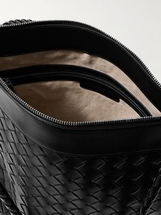 Bottega Veneta's 'Flat Andiamo' messenger bag is crafted from leather using the signature Intrecciato technique and detailed with a silver-tone ‘knot’ embellishment on the front. It has plenty of space for a tablet, water bottle and wallet. Designer Woven Leather Travel Bag, Designer Travel Bag With Woven Leather, Luxury Satchel Bag With Intrecciato Weave, Designer Business Shoulder Bag With Intrecciato Weave, Luxury Woven Leather Shoulder Bag For Travel, Luxury Woven Leather Travel Shoulder Bag, Designer Intrecciato Business Shoulder Bag, Designer Woven Calf Leather Bags, Designer Intrecciato Weave Business Shoulder Bag