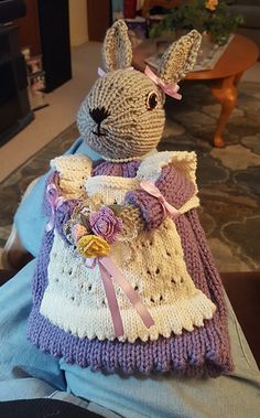 a knitted stuffed rabbit in a dress