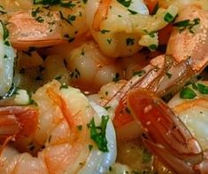 cooked shrimp with parsley and garlic in a skillet