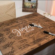 a wooden table with writing on it