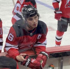 a hockey player sitting on the bench during a game