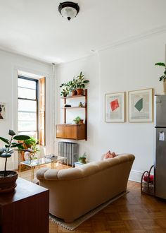 a living room filled with furniture and plants