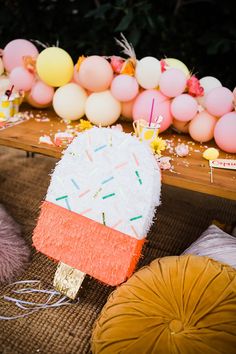 a table topped with lots of cake covered in frosting and sprinkles