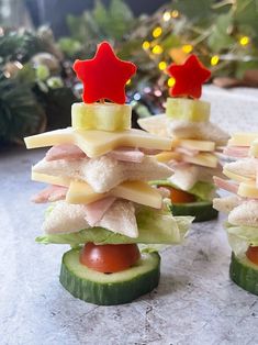 cucumber slices are stacked up with food on them to look like christmas trees