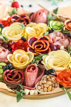 a platter filled with lots of different types of food on top of a table