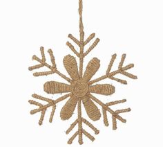 a brown snowflake hanging from a rope