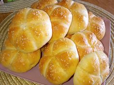 bread rolls with sesame seeds are on a plate