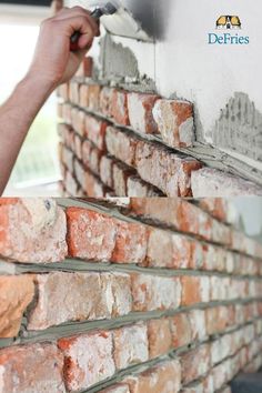 a man is painting a brick wall with a paint roller and some bricks are stacked on top of each other