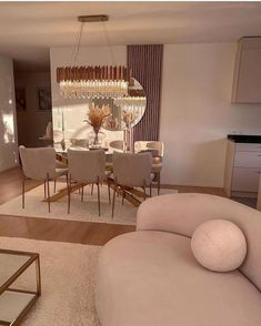 a living room filled with furniture and a chandelier hanging over it's head