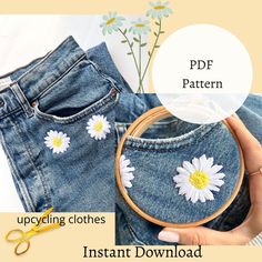 an image of a woman's jeans with daisies on them and the text, upcyling clothes instant download