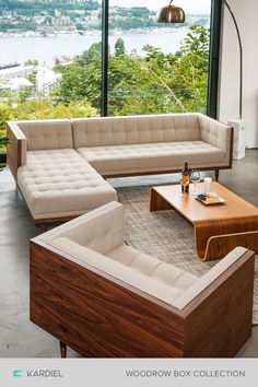 a modern living room with wooden furniture and large windows