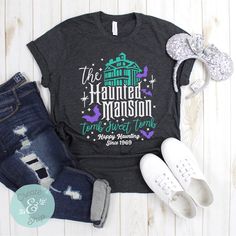 a t - shirt that says the hammer mansion next to some shoes and headbands