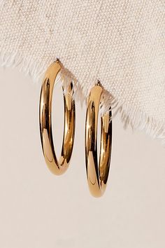 A jewelry staple, these sleek hoops feature a shiny, 18k gold-plated finish and classic silhouette with a lightweight, comfortable design. **Features:** 18k gold-plated hoops, shiny finish, classic silhouette, lightweight and comfortable design, surgical stainless steel posts, 5mm thick, 2" diameter **Why We ❤ It:** These shiny hoops are the perfect pair for everyday wear. | Miranda Frye Freda Hoops at Free People in Gold Jewelry Staples, Comfortable Design, Accessories Jewelry Earrings, Classic Silhouette, Jewelry Earrings Hoops, Boho Outfits, Perfect Pair, Design Features, Everyday Wear