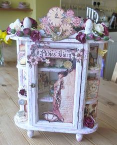 an old fashioned dollhouse is decorated with flowers