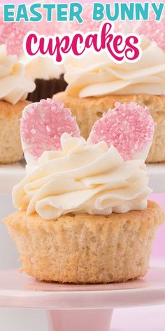 some cupcakes with white frosting and pink sprinkles