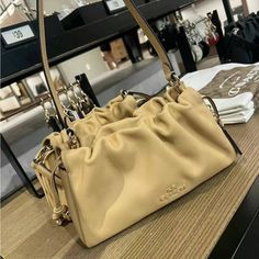 Faye Shoulder Bag With Ruching (Coach Cv529) Gold/Tan Coach Style # Cv529 | Smooth Leather | Inside Zip Pocket | Drawstring And Magnetic Snap Closures, Fabric Lining | Handle With 9" Drop | Detachable Strap With 21 1/2" Drop For Shoulder Or Crossbody Wear | 10 1/4" (L) X 6" (H) X 2 3/4" (W)|Style No. Cv529| Coach Faye Bag, Tan Color, Tote Backpack, Smooth Leather, Coach Bags, Zip Pockets, Bag Lady, Backpacks, Shoulder Bag